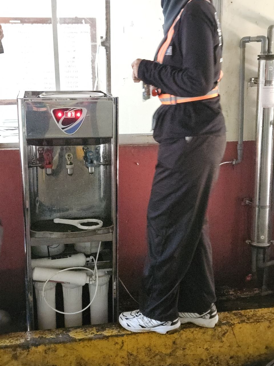 SWFI technician servicing the estate drinking-water dispenser