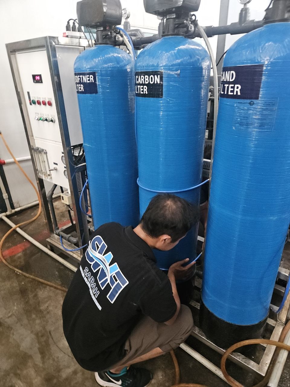 SWFI technician inspecting industrial RO filter vessels