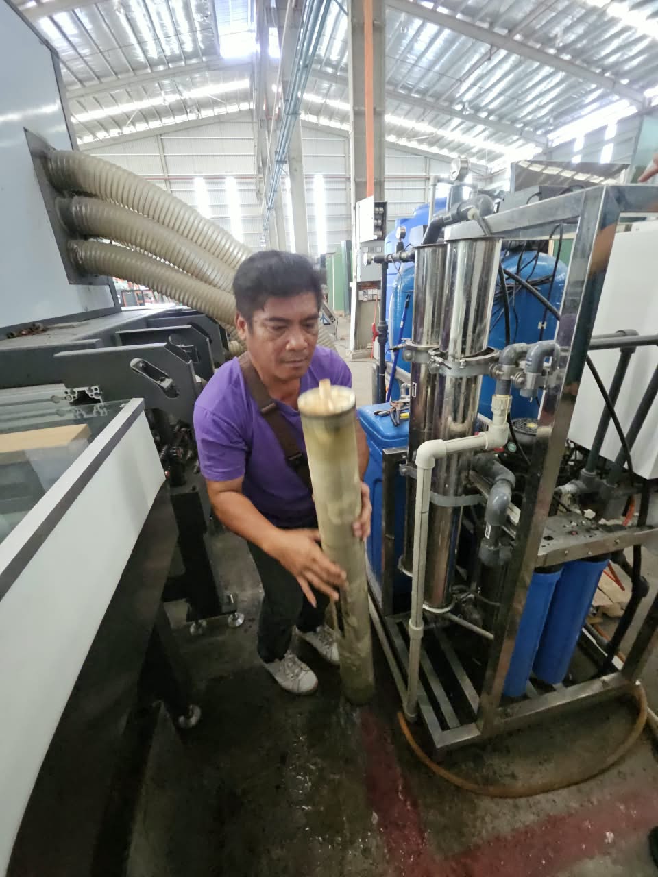 SWFI technician carrying out on-site service at the Nam Heng industrial RO system